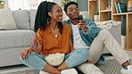 Black couple watching tv, movie streaming service and fast internet for media while eating popcorn at home. Happy man, smile woman and relax people enjoy fun show for cable television entertainment