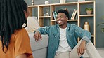 Funny couple eating popcorn for game in living room, comic on date night and smile for black people love in house. Comedy, communication and crazy man and woman playing with food together in home