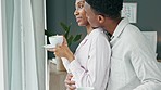 Black couple, hug and morning coffee while showing love and care and looking out the window to watch the view on honeymoon vacation. Happy black man and woman in a committed and healthy relationship