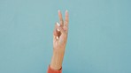 Countdown fingers or hand gesture on a mockup blue wall background. Woman hands counting one, two, three and four, five numbers for a sale, discount or competition with advertising, marketing mock up