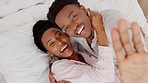 Portrait of a happy black couple hugging on the bed in their modern bedroom at their house. Top view of love, care and romantic man and woman embracing, laughing and bonding in their comfortable home
