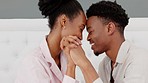 Black couple, love and hands in trust, support or hope in home bedroom, honeymoon hotel or luxury hospitality house. Smile, happy or relax man or woman bonding in forehead touch in security or safety