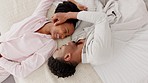 Love, black couple and kiss top view on their bed in the bedroom, hotel or house. Smile, romance and passion or happy dating man and woman bonding, loving or embracing in their home together.

