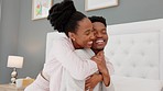 Black couple, love and kiss while hugging in bedroom, house or luxury hotel for honeymoon or bonding on after marriage or anniversary. Happy african man and woman showing affection and appreciation