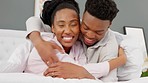 Happy black couple having fun in bed, hug and bonding in a bedroom. Portrait of a caring husband and wife being playful, embracing and affection. Man and woman enjoying cuddle and free time together