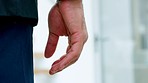 Hand, nervous tick and stress with the fingers of a man twitching nervously in an office closeup. Fear, scared or nerves with a male feeling uncomfortable, uneasy or anxious while standing at work