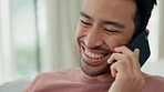 Laughing man, talking phone call and funny conversation, communication and speaking at home on mobile technology. Happy, comic and young guy, smile face and contact discussion on smartphone in house