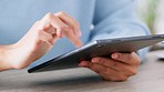 Hands of man using a digital tablet to search, scroll or use online social media app for business marketing and advertising. Company worker typing on mobile device to browse internet, web or website