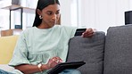 Ecommerce, credit card and woman on digital tablet in online shopping on a sofa at home. Female relaxing on a couch in app store for internet, banking and wifi for purchase on touchscreen technology.