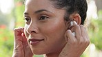 Woman with music on wireless earphones in nature, audio podcast for fitness training motivation and streaming radio before exercise for health. Face of African athlete listening to track in workout