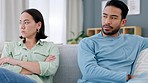 Fight, divorce and angry couple on a sofa in living room at home with husband hurt after erectile dysfunction argument. Marriage, infertility and upset man on the couch with his frustrated young wife
