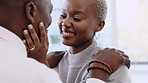 Black couple, love and smile in happy marriage embracing joyful care and comfort together at home. African man and woman in happiness for relationship touching, smiling and hugging in passion romance