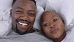 Couple talking and happy on video call while relax in bed while, wave, smile and hug with love. Black man and woman in conversation with a contact while bonding, relaxing and fun in the bedroom 