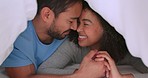 Happy couple, love and trust between man and woman sharing a bond, laugh and commitment while lying close in bed at home. Closeup of interracial man and woman spending free time on weekend together