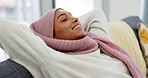 Happy, relax and sleeping Arab woman on the sofa in home, smile with hijab on couch and thinking of success in the living room in house. Happiness Muslim and Islamic girl sleep and rest in apartment