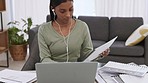Home office, paperwork and remote work with a woman employee working on a laptop in the living room of her house. File, music and finance with a young female at work on a budget, report or project