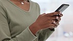 Woman hands with phone searching the internet, texting online and scrolling through social media while at home. One person reading, sending and typing text messages via the web with mobile smartphone