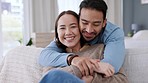 Love, home and portrait of couple hug while relax on living room sofa in new real estate house, property or apartment. Asian man and woman happy, smile and bond together during romantic quality time