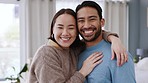 Happy, smile and love mindset of a couple in a house bedroom with happiness. Portrait of a young, relax interracial romantic partners hug together at a home or apartment feeling peace in the morning