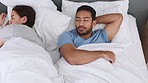 Stress, divorce and depression by angry couple fight in bed, annoyed and ignoring each other. Upset husband and wife with marriage conflict, frustrated and looking sad about problems in the bedroom