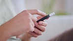 Man hand with phone on social media searching the internet, texting online and scrolling while at home. One person reading, sending and typing text messages via the web with mobile smartphone