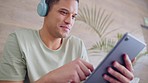 Happy man, digital tablet or headphones for social media, music library playlist or podcast streaming in house living room. Smile, relax or playing internet esports game or searching media app movie