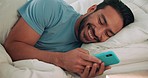 Relax, bed and man typing with phone while chatting on text message with social media app in home. Online, modern dating and person happy with friendly digital connection on the internet. 