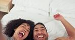 Happy fun couple, selfie and bed in playful relationship laughing together in happiness at home. Interracial man and woman smile, love and live stream joyful funny moments lying in the bedroom