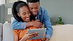 Happy couple networking on social media with a digital tablet while relaxing on the sofa together. Black man and woman on a funny website, meme or online app while sitting on a couch at home.