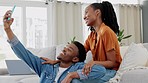 Smile, selfie and a phone, black woman and man on sofa in the living room at home. Friends, lovers and partners, happy couple in love, on couch taking picture or video on smartphone for social media.