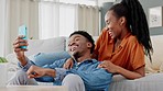 Social media, meme and phone with a couple on the sofa in the living room of their home together. Web, wifi and internet with a young black woman and man feeling happy with a smile in their house