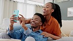 Phone, meme and happy couple on social media laughing at comic, comedy and funny content together at home. People, love and black woman with black man sharing online entertainment on sofa to relax