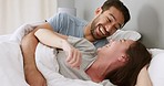 Couple relax in bed together, smile and laugh or show comic expression at a joke, after waking up, in bedroom. Man and woman, in relationship under blanket, react to funny story, at home.