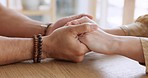 Support, care and couple holding hands on a table to show love and empathy to his partner. Closeup of a man and woman with trust, compassion and unity in their relationship comforting each other.
