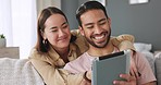 Asian young couple with tablet on social media app watch online web or internet fun meme video on living room sofa. Happy Japanese man and woman in dating relationship together laugh in happiness