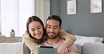 Asian couple, love and man with tablet on social media app watch internet or online web fun video in living room sofa. Happy, smile and relax Japanese people with digital, tech ir streaming at home.