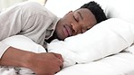 Sleep, relax and dream for a black man home in bed on a weekend morning. Tired, sleeping and dreaming in bedroom alone. Relaxing, peace and comfort with head on pillow for sleepy time in bright room.