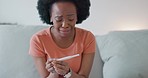 Sad, crying woman with pregnancy test and problem with infertility at home on a sofa. Depression, mental health and depressed or fear of black woman looking at bad results from pregnant kit on couch