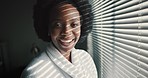 Black woman, morning sun in blinds and laughing in bedroom at window. African beauty, sunshine and relax and start the day with smile. Lazy weekend away, hotel room and a lady in luxury dressing gown