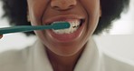 Black woman, brushing teeth and dental grooming in bathroom at hotel, house or home interior. Face zoom on toothbrush, toothpaste and afro person cleaning mouth in healthcare wellness morning routine