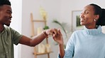 Love, black couple and a dance in their home, house or living room sharing a romantic moment. Smile, romance and man and woman with a special bond dancing in celebration of valentines or anniversary.