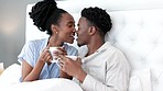 Relax, drink and couple in bed kiss for affection and love in house while resting together. Married black woman and man in happy and romantic relationship enjoy beverage in home bedroom.