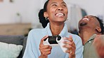 Couple gaming, love kiss and winning at video game on living room sofa, happy with success and celebration of win together. Black woman celebrate being winner of tv games with man in home lounge