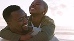 Beach, love and a piggyback, a black woman and man kiss at the sea during sunset. A happy couple, a smile and a romantic evening at the ocean. Waves, sand and romance, summer holiday the African sun.