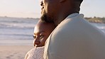 Summer, love and couple hug at a beach, bonding while enjoying the sunset and view of the ocean together. Smile, relax and African American man and woman being loving and sweet on a seaside date