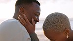 Happy, love and couple gratitude of black woman and man from Kenya laughing on a beach. Happiness of people with a smile together with sea sand, waves and ocean at sunset together embracing summer