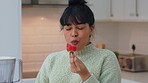 Woman in kitchen happy while eating strawberry, fruit or healthy food for nutrition, wellness or energy. Health, weight loss diet and happiness for nutritionist girl living organic or vegan lifestyle
