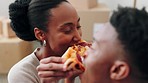 Couple, pizza and eating in new home, real estate or property with cardboard or box in living room. Happy man and woman eat food, fast food or meal for homeowner celebration together on the floor