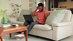 Black man wave during a video call on his laptop in the living room with headphones. Happy male with technology for virtual chat, communication or conversation and greeting online or internet webinar
