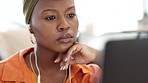 Thinking woman watching webinar, laptop online course, elearning and internet blogging on earphones for music, podcast and ebook work from home. Freelancer, focus and black person planning news ideas